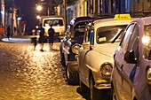 Cuba, Sancti Spiritus Province, Trinidad, taxis on Calle Antonio Maceo, dusk