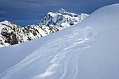 Mount Shuksan, 9,131 ft 2,783 m, with patterns of windblown snow or sastrugi in the foreground, North Cascades Washington