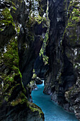 The turquoise mountain stream Tolminska winding through the gloomy Tolminska gorge in the Julian Alps, Goriska, Slovenia