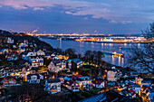 Twilight over Blankenese Treppenviertel with the river Elbe and airbus factory in the background, Hamburg, Germany