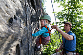 Boy (2 years) climbing in a quarry, Leipzig, Saxony, Germany
