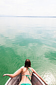 Young woman lying in a boat, Lake Starnberg, Bavaria, Germany