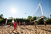 Young people playing beach volleyball, Lake Starnberg, Bavaria, Germany