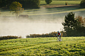 Man cyclocross touring in autumn, Degerndorf, Munsing, Bavaria, Germany