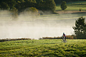 Man cyclocross touring in autumn, Degerndorf, Munsing, Bavaria, Germany