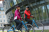 Couple with e-bikes, Munich, Bavaria, Germany