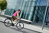 Woman riding an e-bike, Munich, Bavaria, Germany