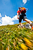 Hiker ascending over the Ghackte to the summit of Hochschwab, Styria, Austria