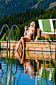 Young woman at a swimming pool of a hotel, Fladnitz an der Teichalm, Styria, Austria