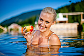 Young woman in a swimming pool of a hotel, Fladnitz an der Teichalm, Styria, Austria