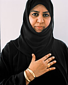 OMAN, Muscat, mid adult woman in burkha, portrait
