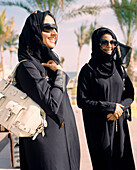 OMAN, Muslim women in traditional clothing at the Barr Al Jissa Resort and Spa, smiling
