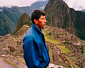 PERU, Machu Picchu, South America, Latin America, side view of a man with Machu Picchu in the background.