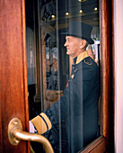 RUSSIA, Moscow, Kremlin, door attendant standing by door of the National Hotel