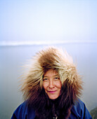 USA, Alaska, portrait of a woman wearing a furry hooded jacket, Point Barrow