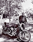 USA, Arizona, biker standing by a motorcycle, Flagstaff (B&W)