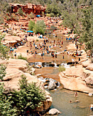 USA, Arizona, Sedona, crowd of people having fun at Oak Creek in the Summertime