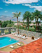 USA, California, Death Valley, woman diving in swimming pool, Furnace Creek Inn