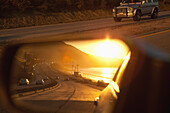USA, California, Malibu, view of the Pacific Coast Highway at sunset as seen in the rear view mirror
