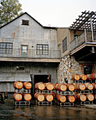 USA, California, an exterior of the Nevada City Winery and freshly filled wine barrels, Gold Country