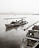CHINA, Hangzhou, family on boat, West Lake (B&W)