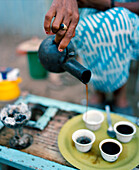 ERITREA, Tio, a woman named Sawit prepares coffee on the side of the road in Tio