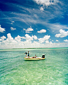 USA, Florida, three men on nautical vessel, fishing for Tarpon, Ivory Keys