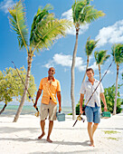 USA, Florida, two men walking on beach with fishing rods and tackle boxes, Islamorada