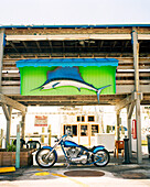 USA, Florida, motorcycle and marlin at a fishing marina, Islamorada