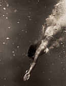 USA, Hawaii, young woman swimming underwater, Kealakekua Bay, The Big Island (B&W)