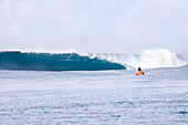 INDONESIA, Mentawai Islands, Kandui Resort, a lone surfer watching a large wave break at Bankvaults