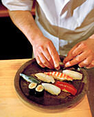 JAPAN, Kyushu, chef preparing fresh sushi served on Karatsu Pottery, Tukunda Restaurant