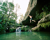 Madagascar, man jumping into pool, Isalo National Park