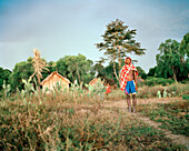 MADAGASCAR, young man standing in field, portrait, Mahazoarivo Village