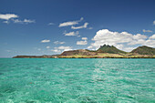 MAURITIUS, Trou D'eau Deuce, sailing in the Indian Ocean off the East coast of Mauritius with the 4 Sisters Mountains in the background