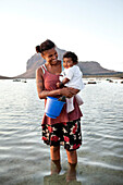 MAURITIUS, a mother and her child hunt for snails at low tide, Baie du Cap