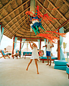 MEXICO, Maya Riviera, girl swinging at a pinyata, Hotel Azul, Yucatan Peninsula