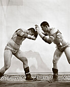MONGOLIA, Ulaanbaatar, portrait of Mongolian wrestlers in traditional dress at the Olympic school training facility (B&W)