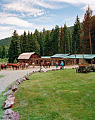 USA, Montana, stable and horses with cowboy and cowgirls, Mountain Sky Guest Ranch