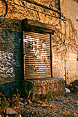 USA, Brooklyn, a loading dock door covered in graffiti at sunset, Williamsburg