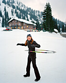 USA, Utah, woman playing in snow hula hooping, Alta Ski Resort