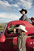 USA, Wyoming, Encampment, kids play in and on an old firetruck, Abara Ranch