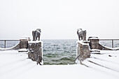 Snow-covered lion sculptures at lake Starnberg, Seeburg, Allmannshausen, Bavaria, Germany