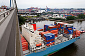 Container ship passing beneath the Koehlbrandbruecke, Hamburg, Germany