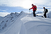 Two backcountry skier standing on snow cornice, Sagtaler Spitzen, Kitzbuehel Alps, Tyrol, Austria