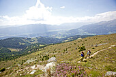 Two female hikers walking the Alpe-Adria-Trail, Nockberge, Carinthia, Austria