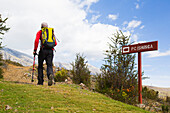 Hiker following signpost to Ishinca Valley, Pashpa, Huaraz, Ancash, Cordillera Blanca, Peru