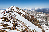 Two skiers on a crest, Mammoth Lakes, California, USA