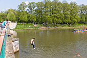 Man jumping from Saxony bridge into water, Clara Zetkin park, Leipzig, Saxony, Germany