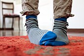 close up feet with striped socks in a house